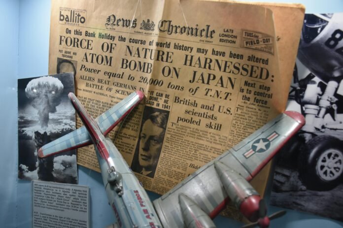 A historical newspaper clipping from the News Chronicle dated August 7, 1945, with the headline announcing the use of the atomic bomb on Japan. The display includes a model airplane, a black-and-white photograph of the Hiroshima explosion, and descriptive text in Turkish about the B-29 bomber and nuclear bombings.